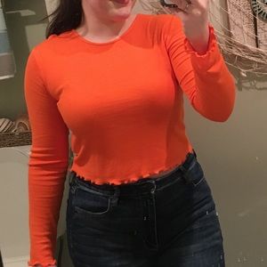 orange long sleeved crop-ish top